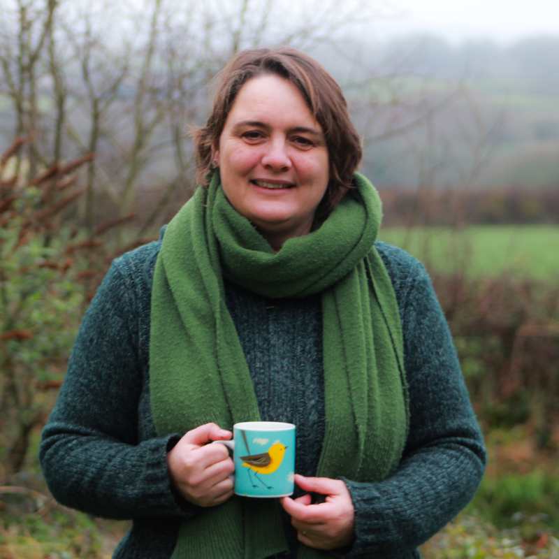 Jacqui Chandler, counselling, psychotherapy and dream therapy, outdoor in garden with cup of tea, smiling