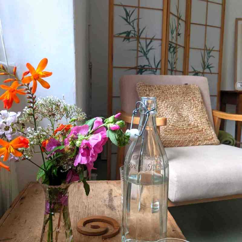 Therapy room with flowers and a bottle of water