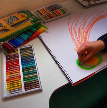 coloured pastels with someone drawing big sweeping movements